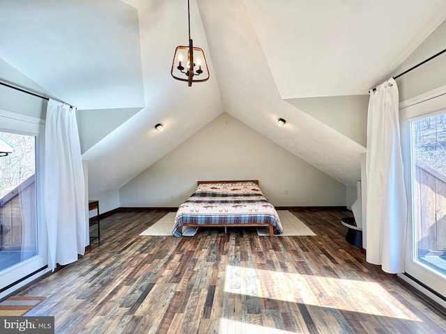unfurnished bedroom with lofted ceiling, wood finished floors, and a notable chandelier
