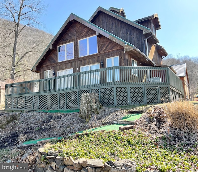 rear view of house with a wooden deck