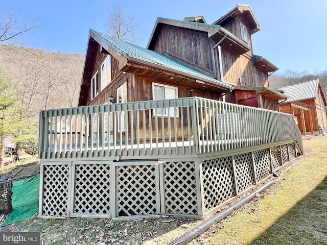 back of property with a deck and metal roof