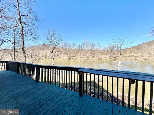 wooden deck with a water view