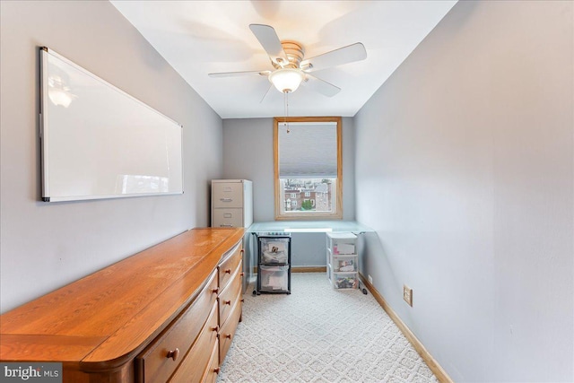 office with ceiling fan and baseboards