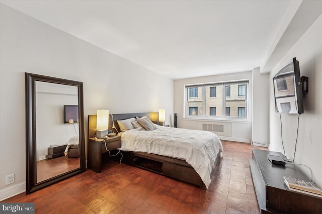 bedroom featuring baseboards, visible vents, and wood finished floors