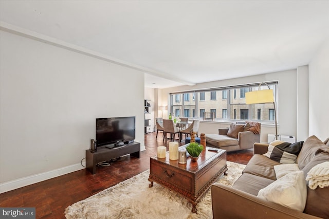 living room featuring baseboards and wood finished floors