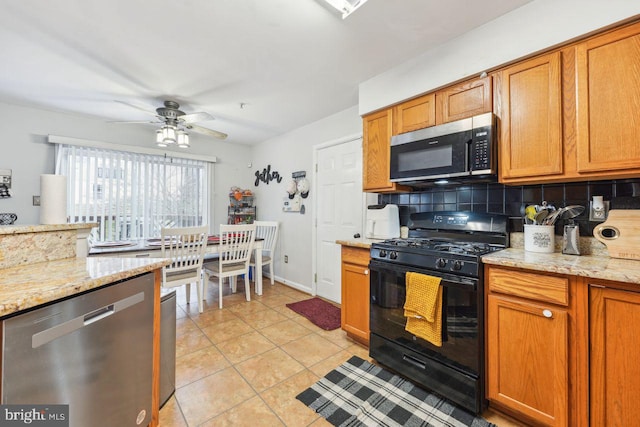 kitchen featuring backsplash, ceiling fan, light tile patterned floors, appliances with stainless steel finishes, and brown cabinetry