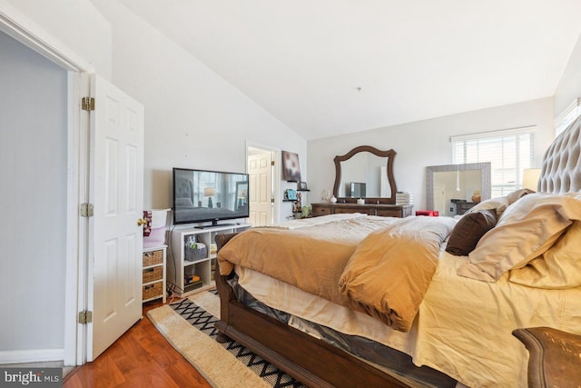 bedroom with lofted ceiling and wood finished floors