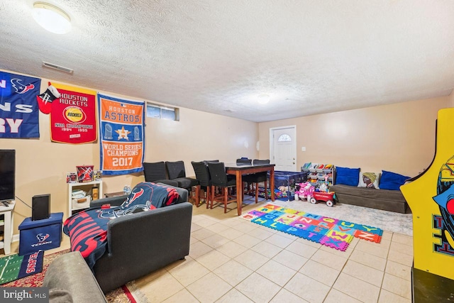 game room featuring visible vents, a textured ceiling, and tile patterned flooring