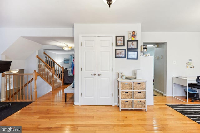 interior space with baseboards and light wood-style floors
