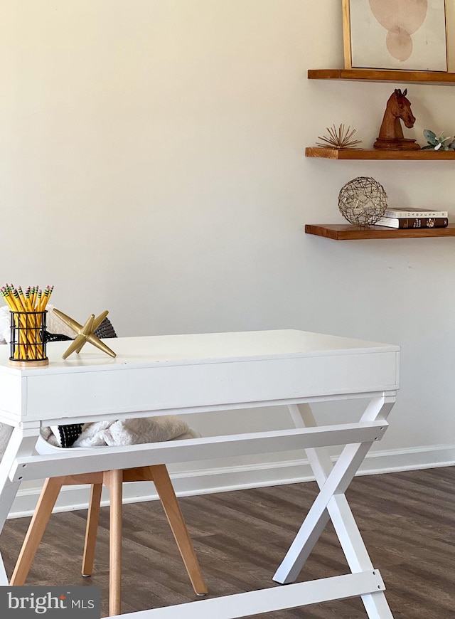 interior details featuring baseboards and wood finished floors