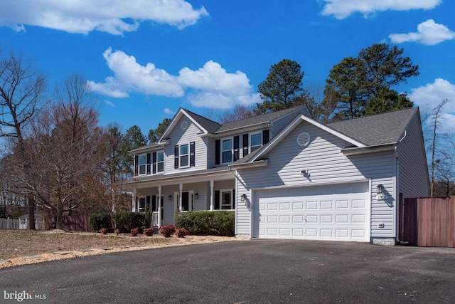 view of front of home with fence, covered porch, a shingled roof, a garage, and aphalt driveway