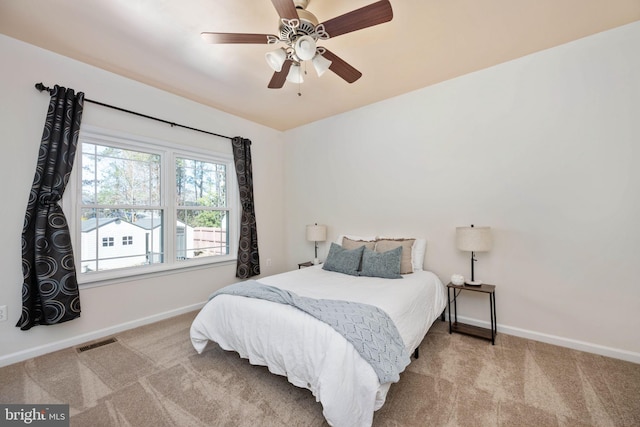 carpeted bedroom featuring visible vents, ceiling fan, and baseboards