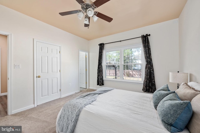 carpeted bedroom featuring baseboards and a ceiling fan