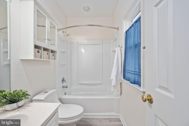 bathroom featuring toilet, vanity, shower / bathing tub combination, and wood finished floors