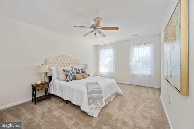 bedroom with carpet flooring, visible vents, baseboards, and ceiling fan