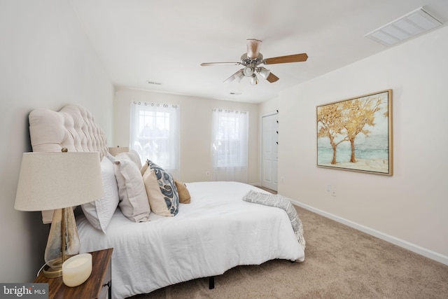 bedroom with visible vents, baseboards, a ceiling fan, and carpet flooring