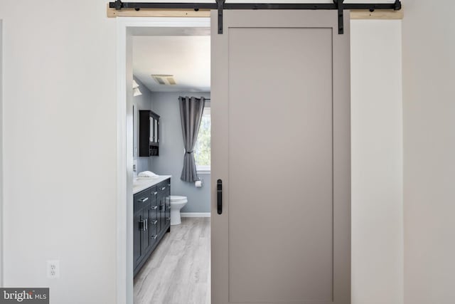 bathroom featuring vanity, wood finished floors, visible vents, baseboards, and toilet