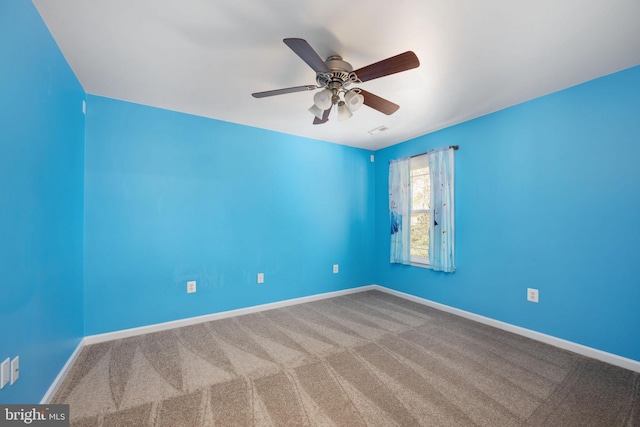 empty room with ceiling fan, baseboards, and carpet floors