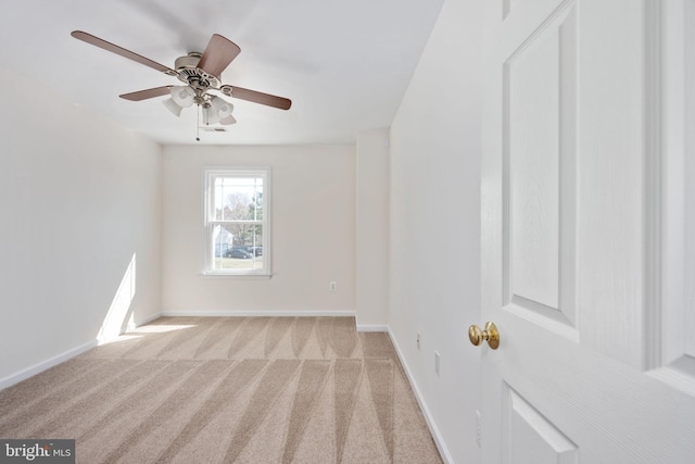 empty room with baseboards and light carpet