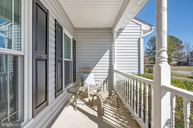 balcony featuring covered porch and a sunroom