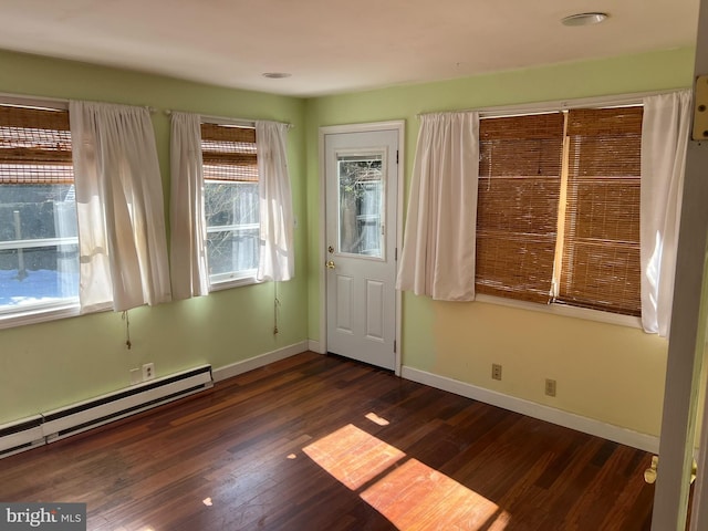 entryway featuring a baseboard heating unit, dark wood-type flooring, and baseboards