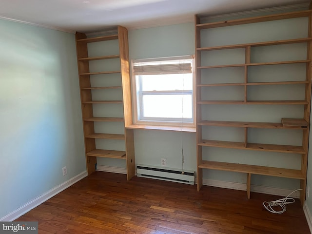 unfurnished bedroom with a baseboard radiator, baseboards, and dark wood finished floors