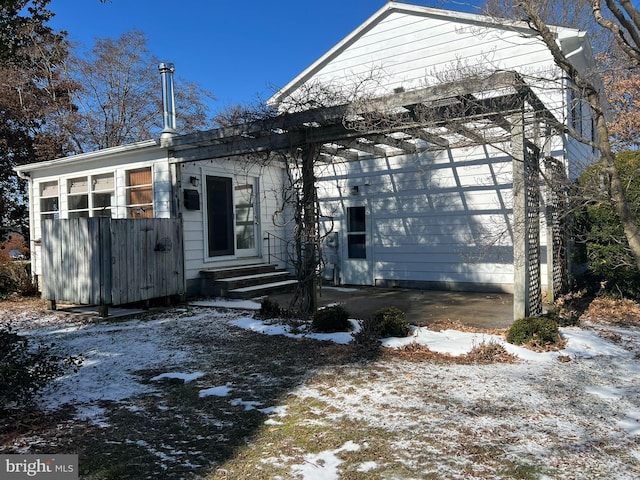 view of front facade with entry steps and a patio area