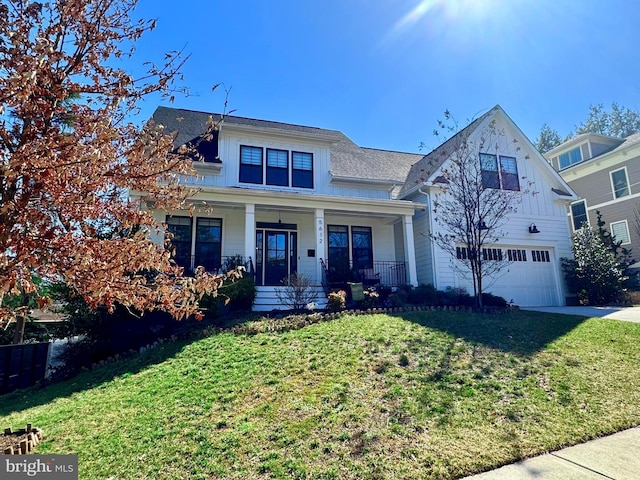 view of front of house featuring a front yard, covered porch, concrete driveway, and an attached garage