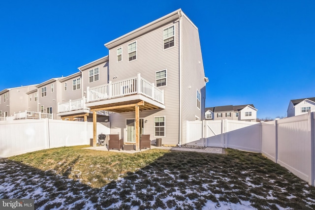 rear view of property featuring a residential view, a patio, and a fenced backyard