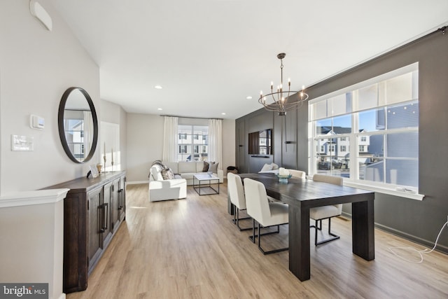 dining room with a notable chandelier, recessed lighting, baseboards, and light wood finished floors