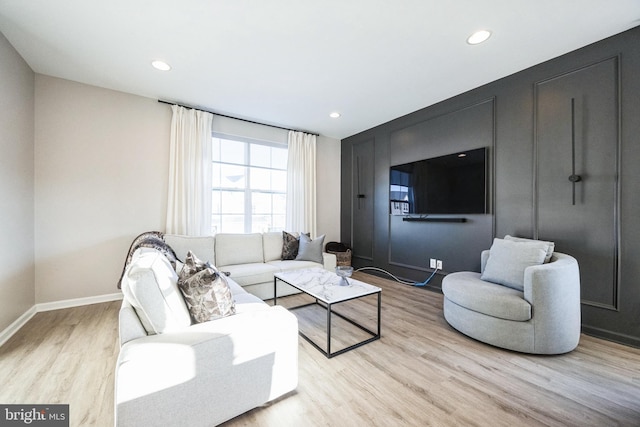 living area with recessed lighting, wood finished floors, and baseboards