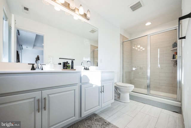 bathroom featuring visible vents, a stall shower, a sink, and double vanity