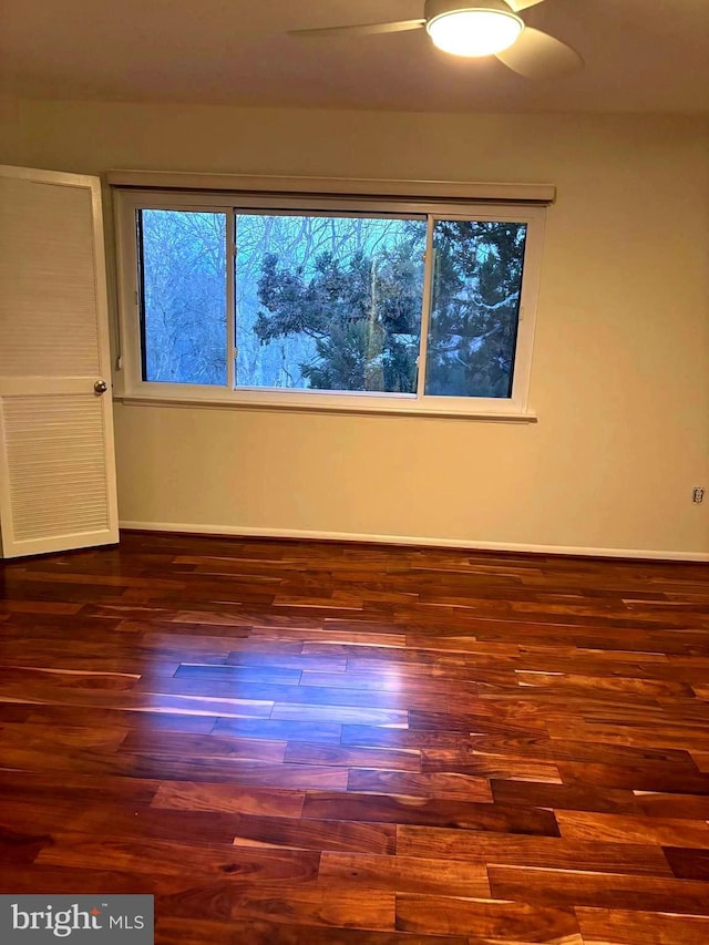 unfurnished room featuring wood finished floors and baseboards