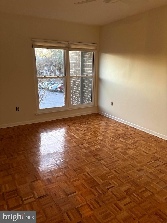 empty room featuring baseboards