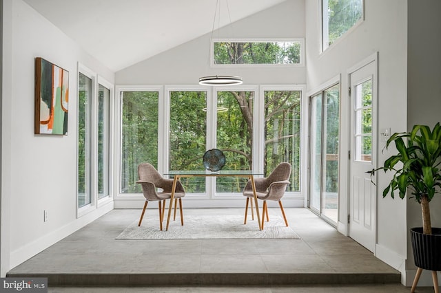 sunroom featuring vaulted ceiling