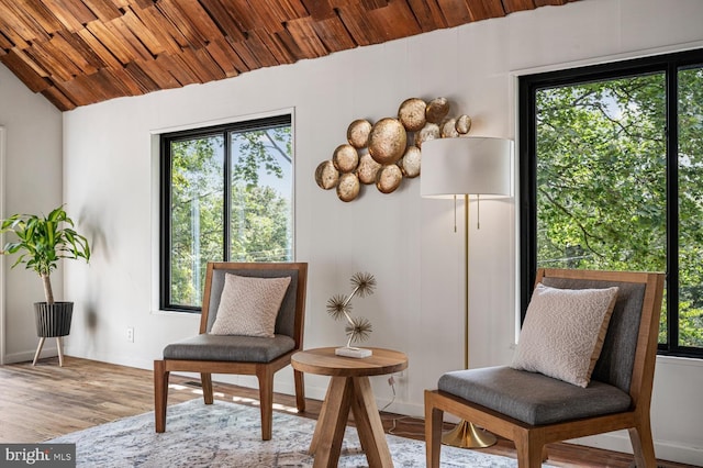 sitting room featuring lofted ceiling, wooden ceiling, baseboards, and wood finished floors