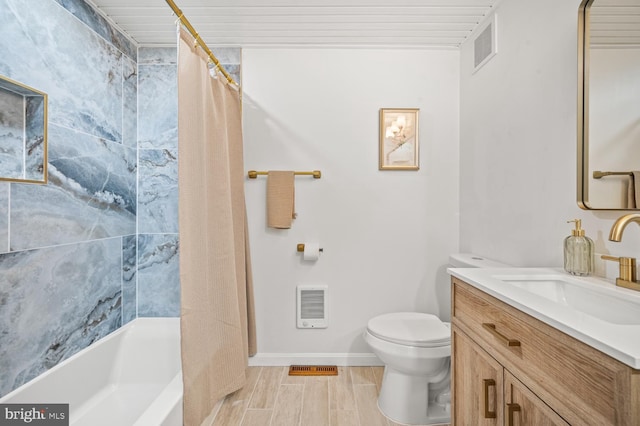 bathroom with toilet, wood finish floors, visible vents, vanity, and baseboards