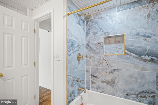 bathroom featuring shower / bathtub combination and wood finished floors