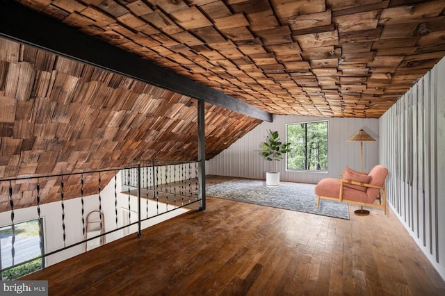 additional living space featuring lofted ceiling with beams, wooden ceiling, and wood-type flooring