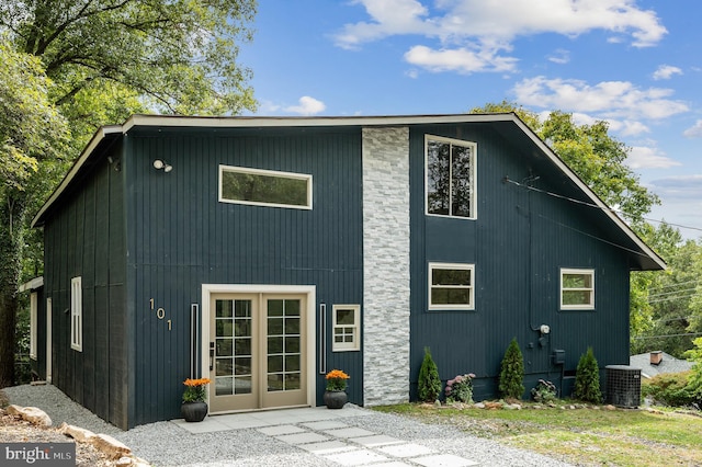 back of property featuring central AC and french doors