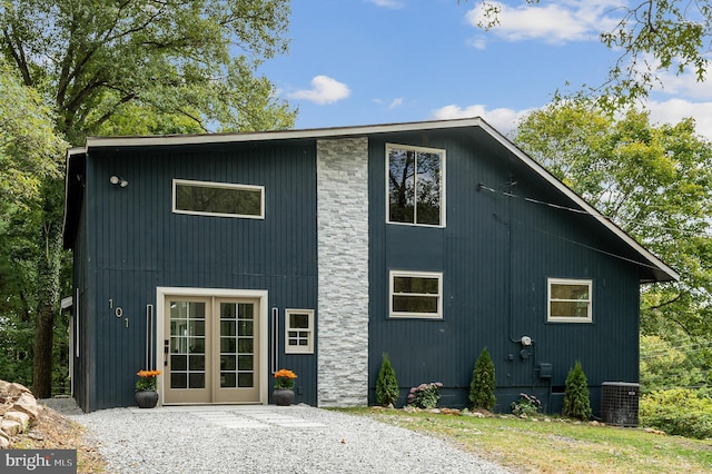 rear view of property with central AC and french doors