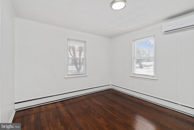 spare room featuring a wealth of natural light, ornamental molding, an AC wall unit, and wood finished floors