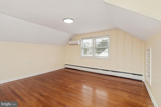 bonus room with lofted ceiling, a wall unit AC, wood-type flooring, baseboards, and baseboard heating