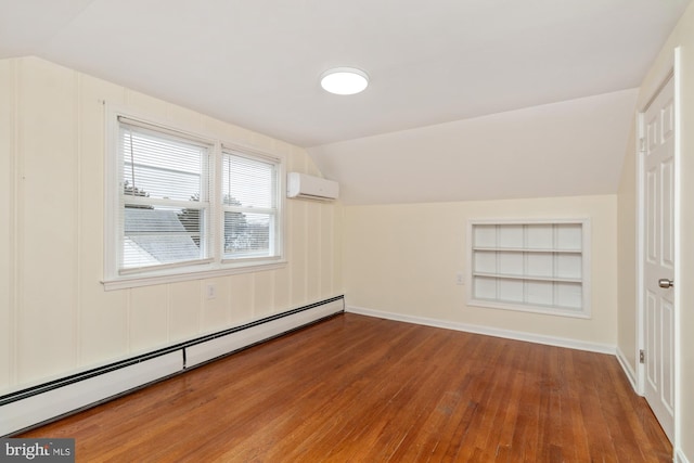 empty room featuring a wall mounted air conditioner, a baseboard radiator, built in features, and vaulted ceiling