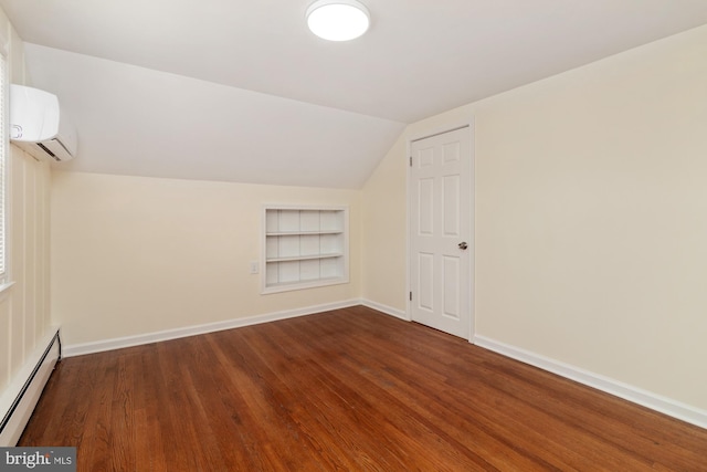 bonus room featuring a baseboard heating unit, baseboards, built in features, a wall unit AC, and wood finished floors