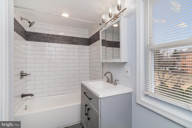 bathroom featuring vanity, a wealth of natural light, shower / bathtub combination, and a chandelier