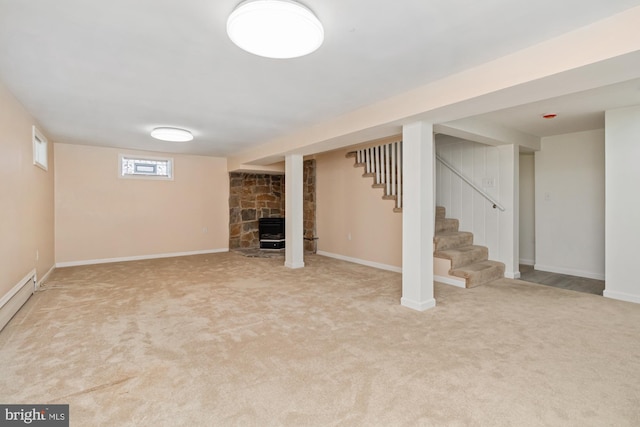 below grade area featuring stairway, a fireplace, baseboards, and carpet