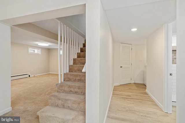 stairway featuring carpet, baseboards, baseboard heating, recessed lighting, and wood finished floors