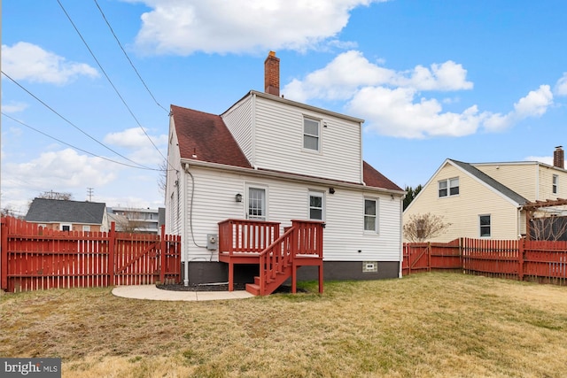 back of house with a patio area, a lawn, a fenced backyard, and roof with shingles