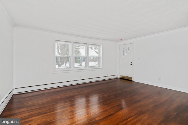 empty room featuring baseboard heating, crown molding, and wood finished floors