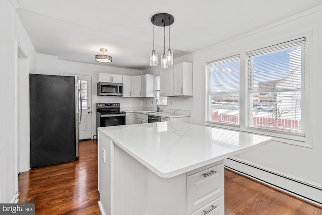 kitchen featuring a wealth of natural light, stainless steel appliances, dark wood-style floors, and a baseboard heating unit