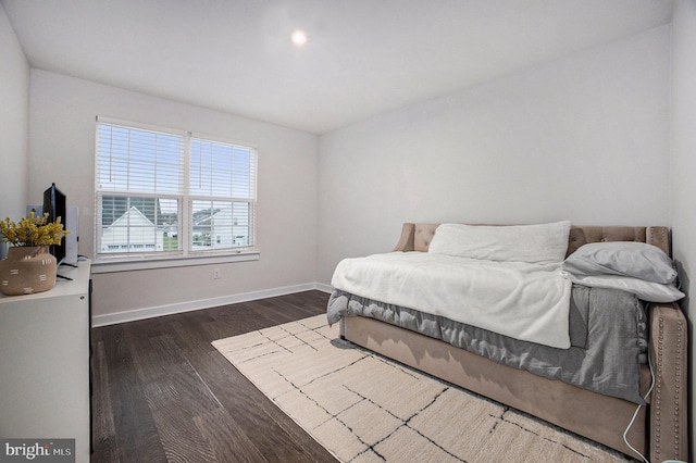 bedroom featuring baseboards and dark wood finished floors